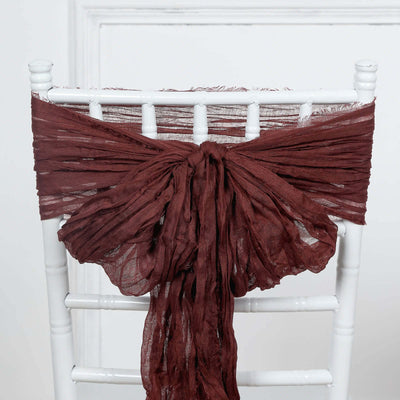 Burgundy sheer chair sash tied on a white chiavari chair