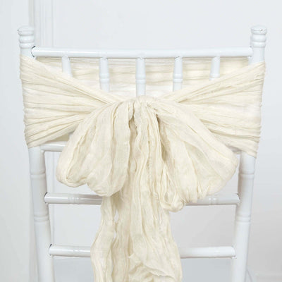 Ivory chiffon chair sash tied in a bow on a white chair