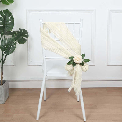 Chair with ivory draping and rose decoration in a styled setting.