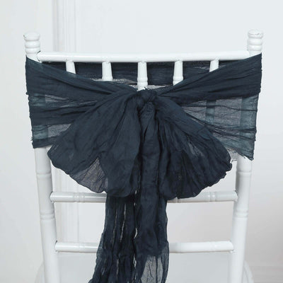 Navy blue chiffon chair sash tied on a white chair