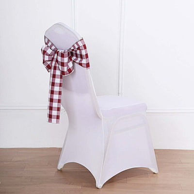 White chair with a red and white checked bow on the back.