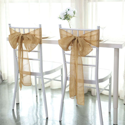 Elegant burlap chair sashes tied in bows for a stylish table setting.