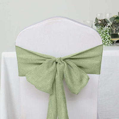 Green chair sash tied in a bow on a white chair at a table setting.
