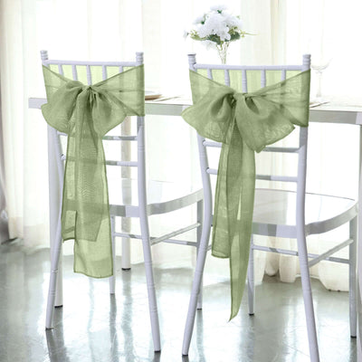 Linen chair sashes in soft green tied in bows on white chairs