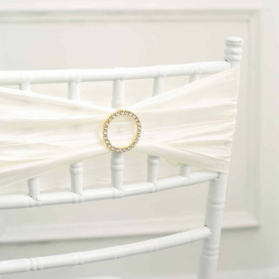 White chair sash with rhinestone buckle on a chiavari chair.