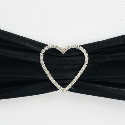 Black fabric with a heart-shaped rhinestone brooch accent