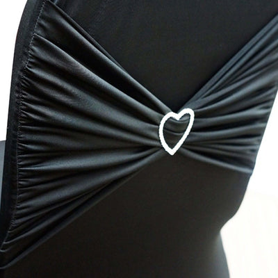 Black chair cover with heart-shaped embellishment for elegant decor.