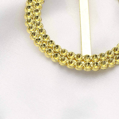 Gold rhinestone hair accessory with a circular design.