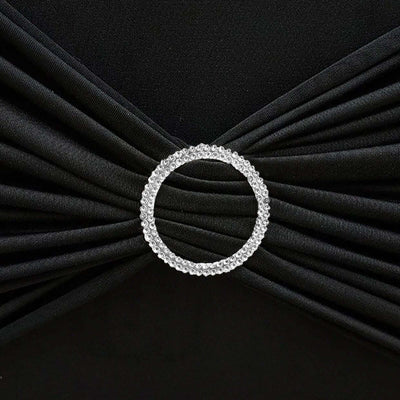 Rhinestone-embellished black fabric with pleats and circular accent.