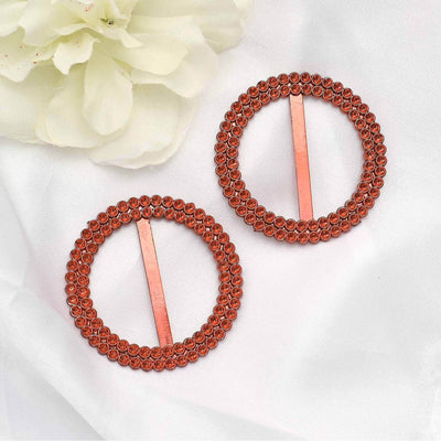 Pair of elegant copper hair clips adorned with sparkling stones.