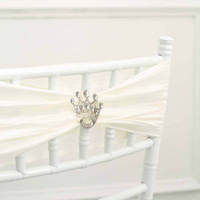 White chair sash with jeweled crown decoration for elegant events