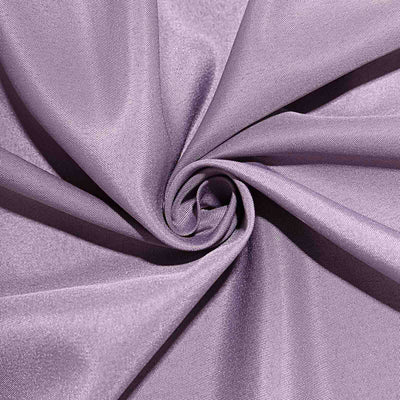 Purple fabric with a smooth texture, elegantly arranged in a spiral.