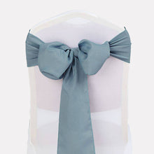 A polyester chair sash in blue satin tied around a chair#whtbkgd