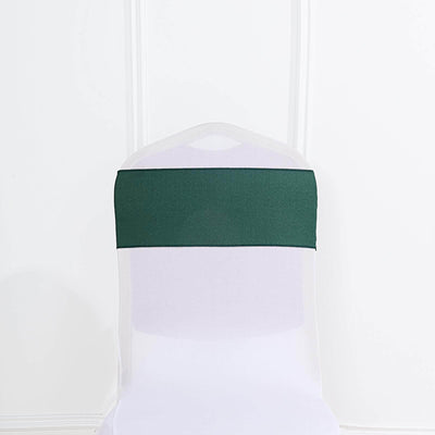 Green chair cover sash on a white chair against a plain background