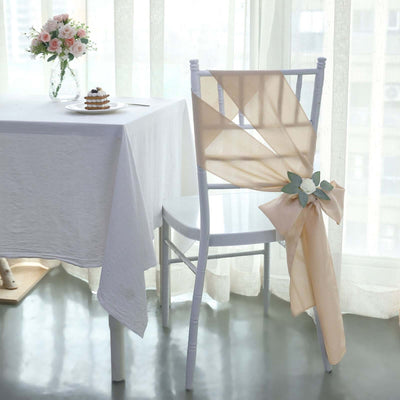 Elegant chair decor with soft beige fabric and floral accents in a bright setting.