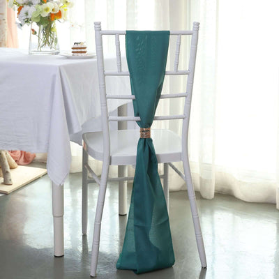 Teal chair sash tied elegantly on a white chiavari chair in a bright setting.