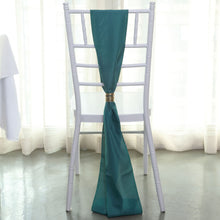 A teal polyester chair with a teal scarf tied around it