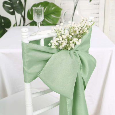 Green chair sash with bow and flowers, perfect for event decor.