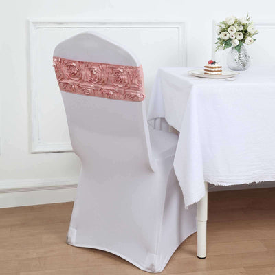 Elegant white chair cover with pink rose detail on the back, styled at a dining table.