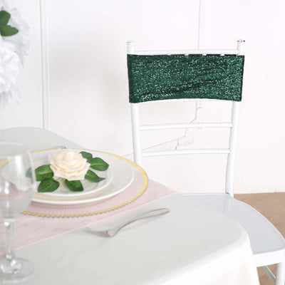 White chiavari chair with green sequin sash at a dining table setting.