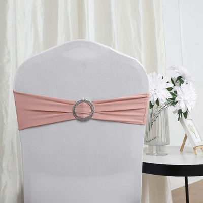 Peach chair sash with decorative silver ring on a white chair