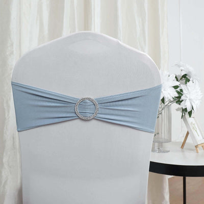 Blue chair cover with rhinestone buckle on a white chair.