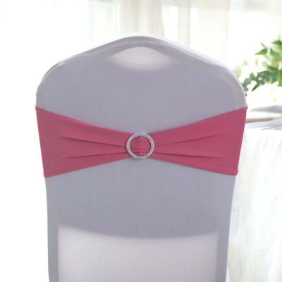 Pink chair sash with rhinestone buckle on a white chair.
