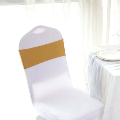 White chair cover with a gold band, styled for an elegant dining setup.