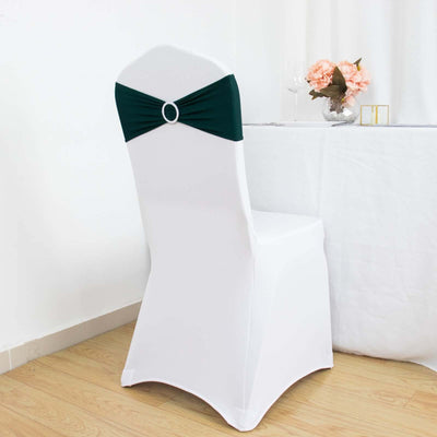 Elegant white chair cover with green bow detail for events or weddings.