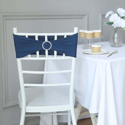 Navy chair sash with rhinestone buckle on a white chair in an elegant setting.