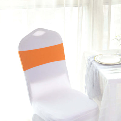 White chair cover with orange sash, perfect for events and celebrations.