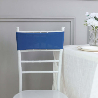 Blue chair cover on a white Chiavari chair at a dining table.