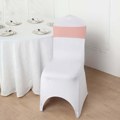White chair cover with pink sash on a table setting.