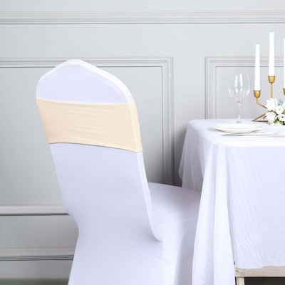 Elegant beige chair cover on a white chair at a dining table setting.
