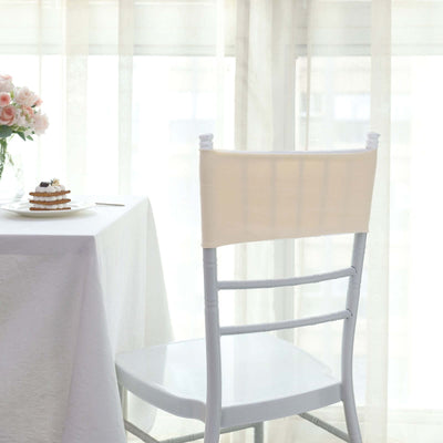 Elegant chair cover in a bright dining setting with soft curtains.