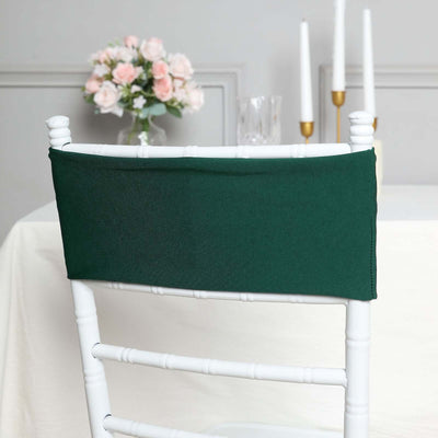 Green chair cover displayed on a white chair in a decorated dining setting.