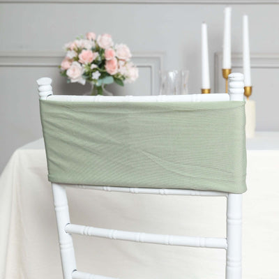 Green chair cover on white chiavari chair in elegant dining setting.