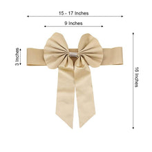 A stylish champagne satin & faux leather bow with measurements on it