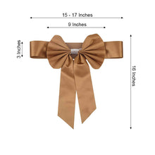 Gold satin & faux leather bow with measurements of 15-17 inches and 16 inches