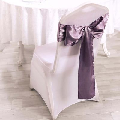 Elegant white chair with purple satin bow, perfect for event decor.