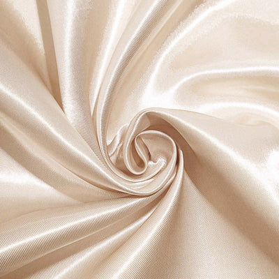 Silky beige fabric with a smooth texture in a swirling pattern.
