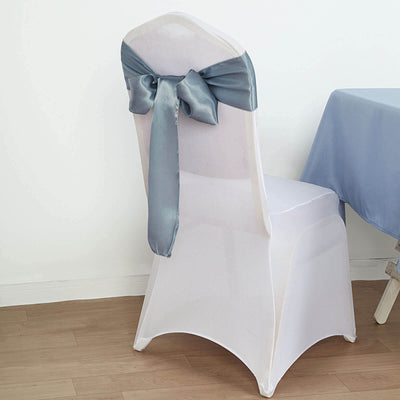 White chair cover with a blue satin bow tied at the back.