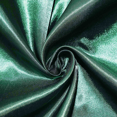 Green satin fabric swirl showing smooth texture and sheen.