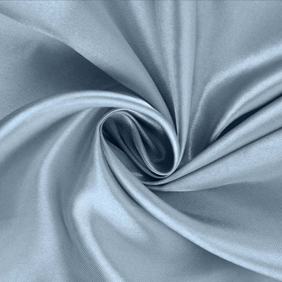Blue silk fabric swirl texture close-up.