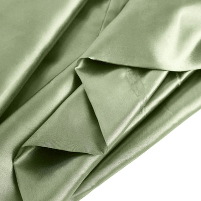 Green satin fabric folded elegantly, showcasing smooth texture and sheen.