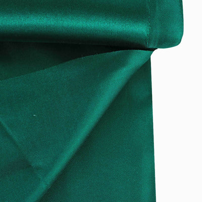 Emerald green fabric draped elegantly, showcasing its smooth texture.