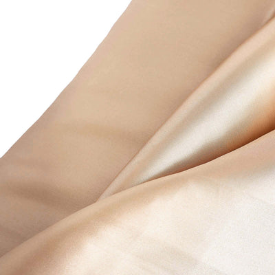 Smooth beige satin fabric draped elegantly, showcasing its luxurious texture.