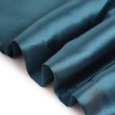 Teal satin fabric draped elegantly, showcasing smooth texture and rich color.