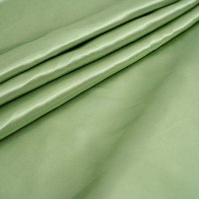 Soft green satin fabric draped elegantly in folds.