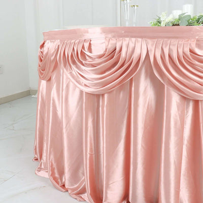 Pink satin tablecloth with elegant draping for events and decorations.